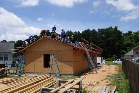 Our progress come lunchtime. Shingles cover 2/3 of the roof! Group shot on the roof.